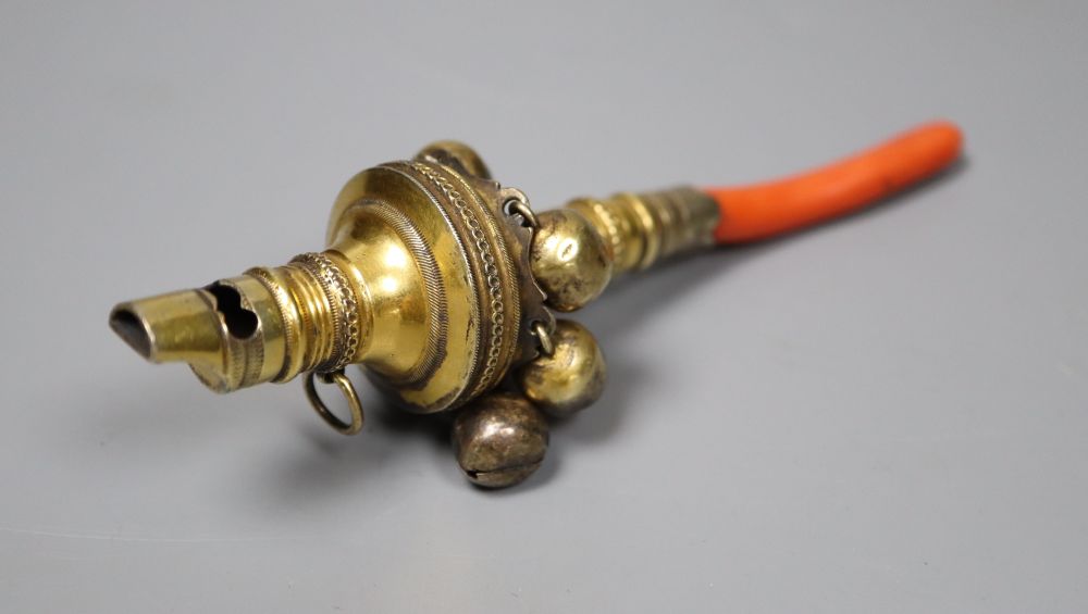 A George III silver gilt and coral set childs rattle, Matthew Chawner, London, 1806, 12.2cm, gross 37 grams.